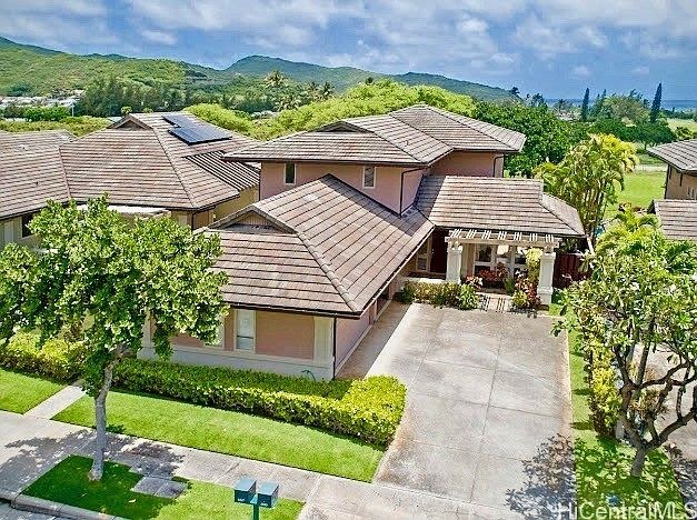 Front elevation of 1047 Koko Kai Place with tile roofline and tropical landscaping