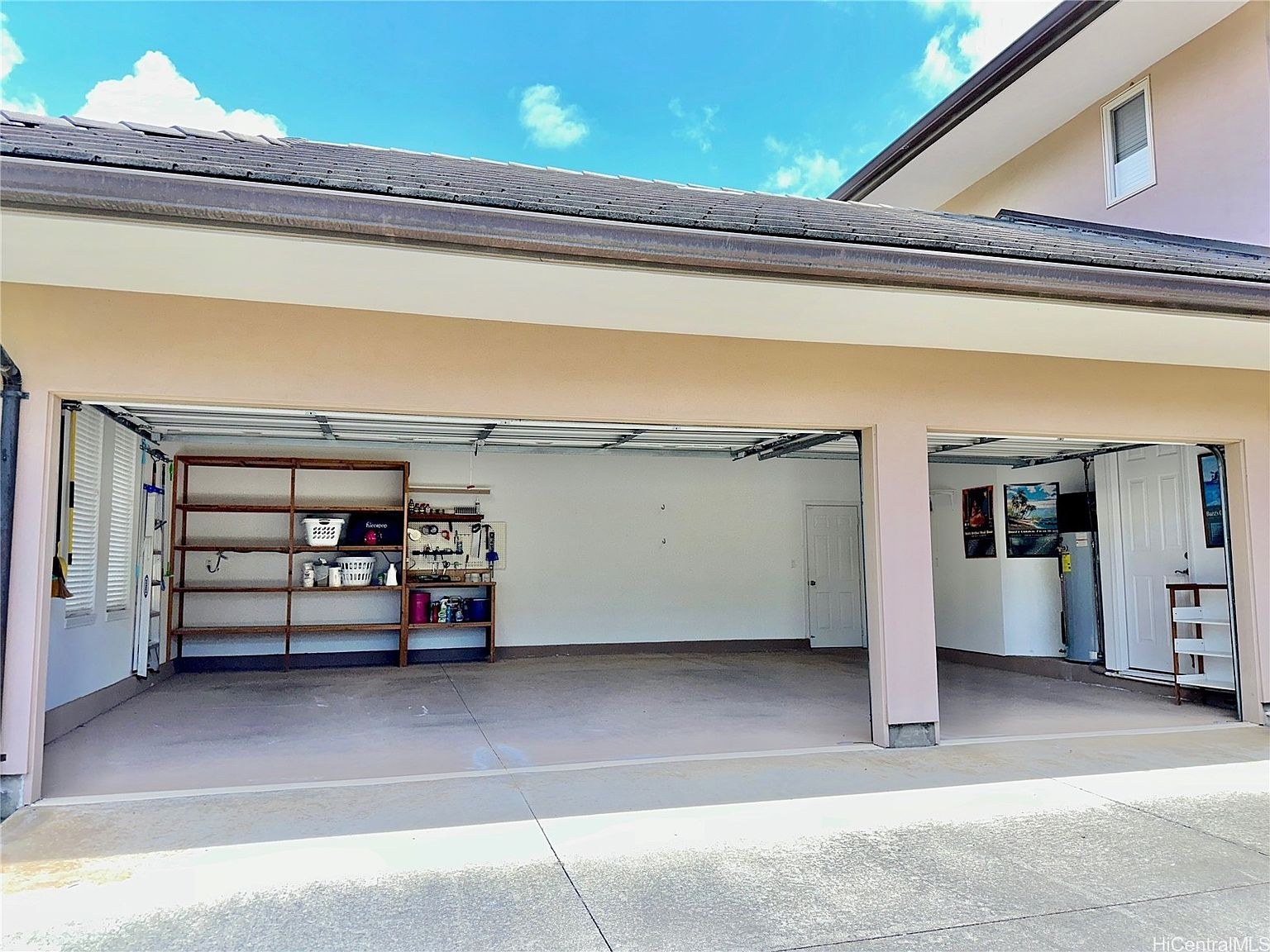 Three-car garage with shelving and bright interior light